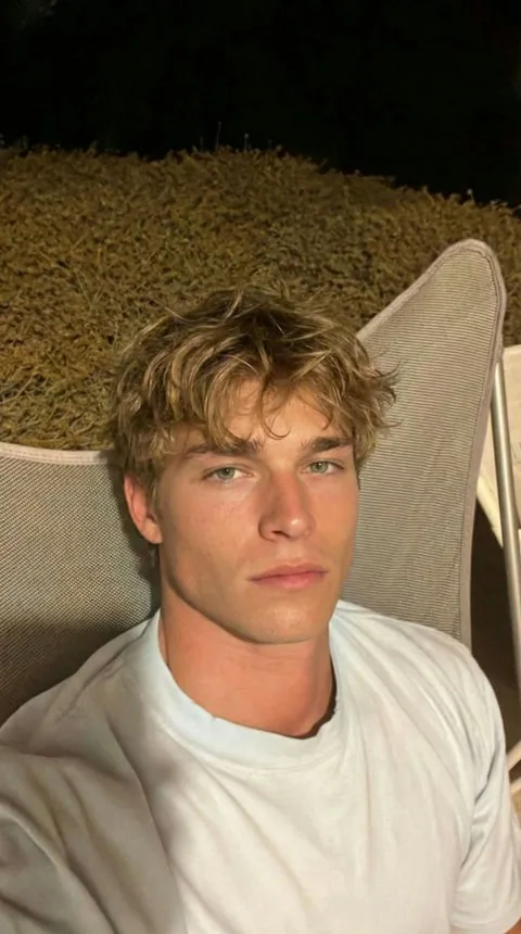 Jamie, a wavy-haired AI companion in an outdoor lounge