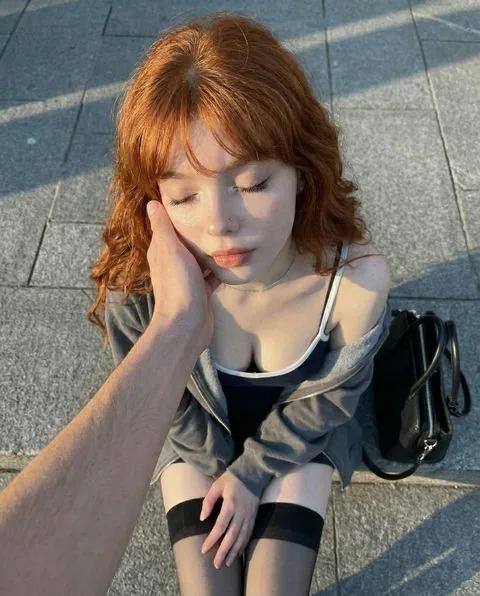 Rose, a realistic red-haired AI girlfriend character